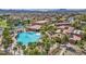 Expansive community pool with a hot tub surrounded by lush landscaping and palm trees in a well-maintained neighborhood at 1108 Via Della Curia, Henderson, NV 89011