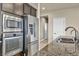 Kitchen with stainless steel appliances, including a built in microwave and oven, and granite countertops at 1108 Via Della Curia, Henderson, NV 89011