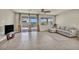 Bright living room with tile floors, access to the backyard, and a comfortable seating area at 1108 Via Della Curia, Henderson, NV 89011