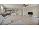 An open-concept living area showcasing tile flooring and dark cabinetry, connecting the kitchen to the living space at 1108 Via Della Curia, Henderson, NV 89011