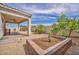 Cozy covered patio area with desert landscaping, perfect for outdoor relaxation and entertaining at 1108 Via Della Curia, Henderson, NV 89011
