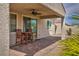 Covered patio featuring a brick floor, ceiling fan, and outdoor seating perfect for relaxing or entertaining at 1108 Via Della Curia, Henderson, NV 89011