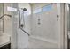 Modern shower with marble-look walls, a rain shower head and a built-in bench at 1108 Via Della Curia, Henderson, NV 89011
