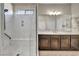 Luxurious walk-in shower featuring marble walls and a built-in seat at 1108 Via Della Curia, Henderson, NV 89011