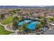 Aerial view of community tennis courts with well-maintained landscaping, trees and nearby parking at 1108 Via Della Curia, Henderson, NV 89011