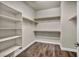 Walk-in closet with built-in shelving and hardwood floors at 1108 Via Della Curia, Henderson, NV 89011