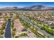 Aerial view of a Primary-planned community nestled near mountains with paved roads at 12122 High Country Ln, Las Vegas, NV 89138