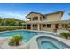 Large pool and spa in a landscaped backyard, creating an ideal setting for relaxation and entertainment at 12122 High Country Ln, Las Vegas, NV 89138