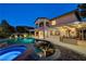 Expansive backyard with a pool, outdoor kitchen, and covered patio, perfect for outdoor living and entertaining at 12122 High Country Ln, Las Vegas, NV 89138