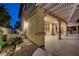 Backyard patio featuring covered seating area and manicured lawn at 12122 High Country Ln, Las Vegas, NV 89138