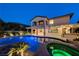 Inviting backyard pool with hot tub, outdoor kitchen, and covered patio perfect for evening relaxation and entertaining at 12122 High Country Ln, Las Vegas, NV 89138