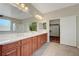 Bathroom featuring double sinks, large mirrors, walk-in shower, and soaking tub at 12122 High Country Ln, Las Vegas, NV 89138
