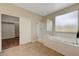 Bathroom featuring a tub, standup shower, and large window at 12122 High Country Ln, Las Vegas, NV 89138