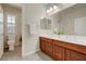 Bathroom featuring dual sinks, vanity, toilet and shutters at 12122 High Country Ln, Las Vegas, NV 89138