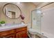 Bathroom with marble vanity, vessel sink, decorative mirror, and a shower with glass doors at 12122 High Country Ln, Las Vegas, NV 89138