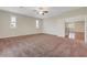 Spacious bedroom with plush carpeting, ceiling fan, and large windows at 12122 High Country Ln, Las Vegas, NV 89138