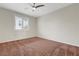 Bright bedroom featuring a ceiling fan and large window at 12122 High Country Ln, Las Vegas, NV 89138