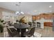 Open-concept kitchen and dining area with modern appliances, ample counter space, and stylish light fixtures at 12122 High Country Ln, Las Vegas, NV 89138