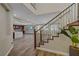 Inviting entryway showcasing wood floors, a staircase with decorative iron railings, and views of the kitchen at 12122 High Country Ln, Las Vegas, NV 89138