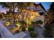 Picturesque exterior view of a home featuring attractive landscaping, stone accents, and charming front entrance at 12122 High Country Ln, Las Vegas, NV 89138