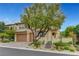 Charming home with beautiful landscaping, including mature trees and desert plants at 12122 High Country Ln, Las Vegas, NV 89138