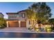Charming two-story home with a well-manicured front yard, mature trees, and a convenient two-car garage at 12122 High Country Ln, Las Vegas, NV 89138