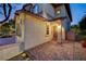 Attractive home featuring a brick driveway and walkway, complemented by manicured landscaping and a cozy front porch at 12122 High Country Ln, Las Vegas, NV 89138