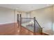 Upstairs hallway with wood flooring and decorative railing overlooking the foyer at 12122 High Country Ln, Las Vegas, NV 89138