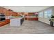 Large kitchen with stainless appliances, a center island with a countertop, and wood cabinets at 12122 High Country Ln, Las Vegas, NV 89138