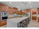Bright kitchen featuring a large island, stainless steel appliances, and wood cabinets with lighting at 12122 High Country Ln, Las Vegas, NV 89138