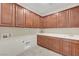 Laundry room with cabinets, tile floor, sink and counter at 12122 High Country Ln, Las Vegas, NV 89138