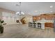 Bright open-plan living room featuring wood floors, a fireplace, and a kitchen island with seating at 12122 High Country Ln, Las Vegas, NV 89138
