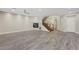 Bright living room with wood-look flooring, a fireplace, and staircase access to upper level at 12122 High Country Ln, Las Vegas, NV 89138