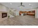 Open-concept living area showcasing wood-look floors, a fireplace, and a kitchen with a center island at 12122 High Country Ln, Las Vegas, NV 89138