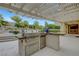 Outdoor kitchen with stainless steel grill under a pergola, perfect for outdoor entertaining at 12122 High Country Ln, Las Vegas, NV 89138