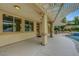 Covered patio with pergola, multiple windows, and outdoor kitchen area near the pool at 12122 High Country Ln, Las Vegas, NV 89138