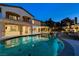 Backyard pool and patio with lush landscaping and lighting at 12122 High Country Ln, Las Vegas, NV 89138