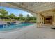 Swimming pool with spa, adjacent to an outdoor covered patio area with a fireplace at 12122 High Country Ln, Las Vegas, NV 89138