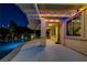 Backyard pool with an illuminated patio, showcasing outdoor living and entertaining at its finest at 12122 High Country Ln, Las Vegas, NV 89138