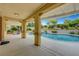 Beautiful pool and spa with a covered patio, outdoor kitchen, and landscaped yard, ideal for entertaining at 12122 High Country Ln, Las Vegas, NV 89138