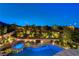 Elevated view of the pool and backyard area with a firepit and lush landscaping at 12122 High Country Ln, Las Vegas, NV 89138