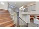 Elegant staircase and railings lead to an open, airy upstairs hallway at 12122 High Country Ln, Las Vegas, NV 89138