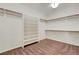 Walk-in closet featuring built-in shelves and wooden hanging rods at 12122 High Country Ln, Las Vegas, NV 89138