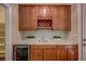 Elegant wet bar area featuring a wine cooler, wooden cabinets, and counter space for entertaining at 12122 High Country Ln, Las Vegas, NV 89138