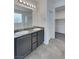 Bathroom featuring a double sink vanity, granite countertop, ample lighting, and a walk-in closet at 138 Scarlett View Ave, North Las Vegas, NV 89031
