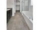 Bathroom showcasing a soaking tub, shower with glass door, and elegant tile flooring at 138 Scarlett View Ave, North Las Vegas, NV 89031