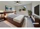 Comfortable bedroom featuring a ceiling fan, neutral walls, and a large window for natural light at 138 Scarlett View Ave, North Las Vegas, NV 89031