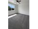 Light-filled bedroom with plush carpet, large window offering neighborhood views, and neutral paint at 138 Scarlett View Ave, North Las Vegas, NV 89031