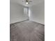 This bedroom features neutral carpeting, a ceiling fan, and a bright window at 138 Scarlett View Ave, North Las Vegas, NV 89031