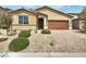 Charming single-story home with desert landscaping, a brick driveway and 2-car garage at 138 Scarlett View Ave, North Las Vegas, NV 89031